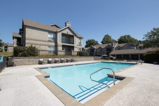 The pool area, features clear blue water and plenty of space to relax.